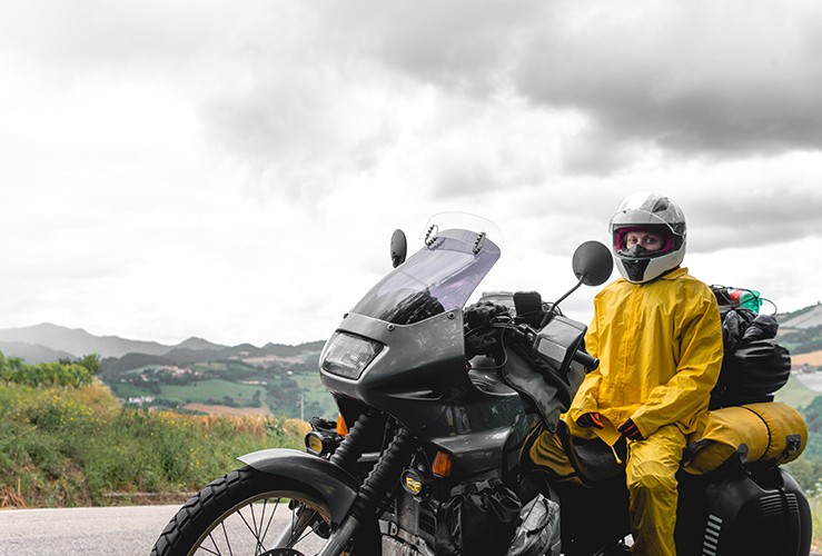 Motorcyclist wearing yellow raincoat