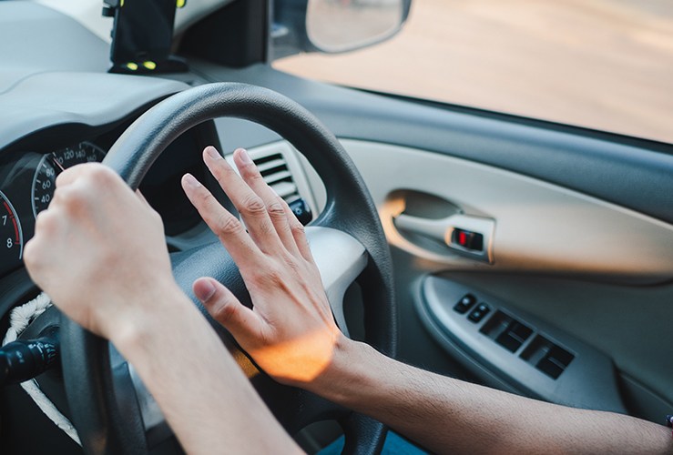 Image of a driver beeping their horn