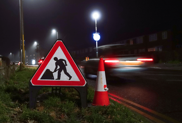 Roadworks sign and traffic cone