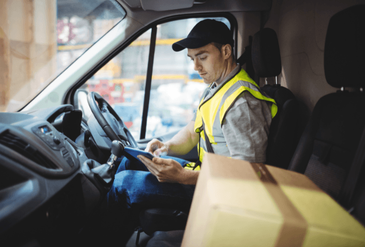 Delivery driver entering details on tablet