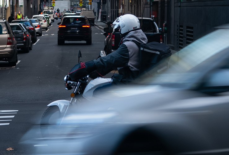 Motorcycle courier riding in a city 