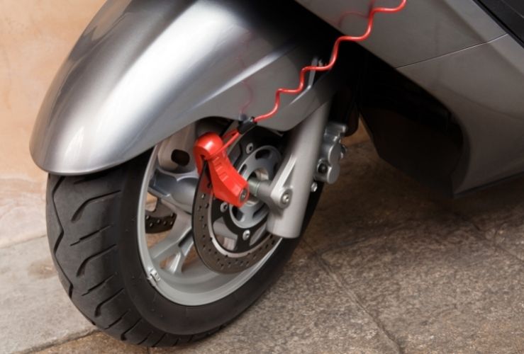 Image of motorbike lock on front wheel