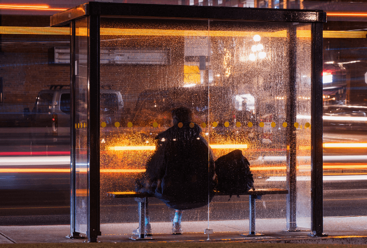 Man sitting at a bus stop