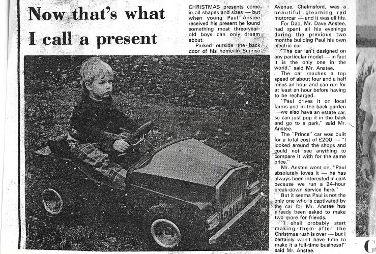 Press clipping of Paul in the car his dad made him for Christmas when he was 3 years old
