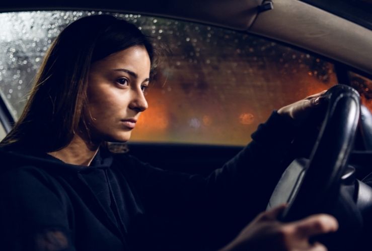 Woman driving car at nighttime