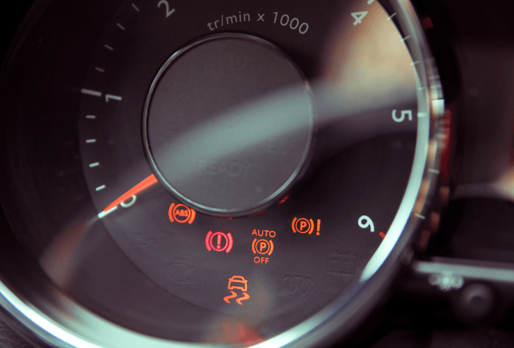 Car dashboard with warning lights lit up