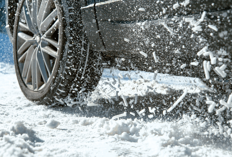 Car wheel churning up snow