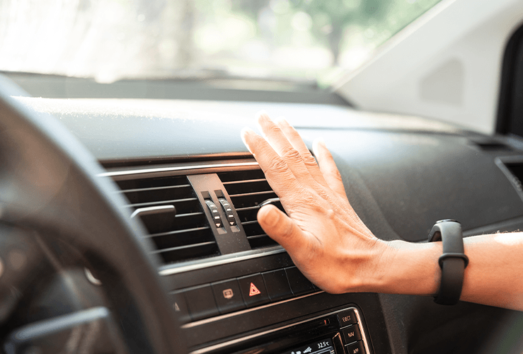 Hand in front of the car air vents