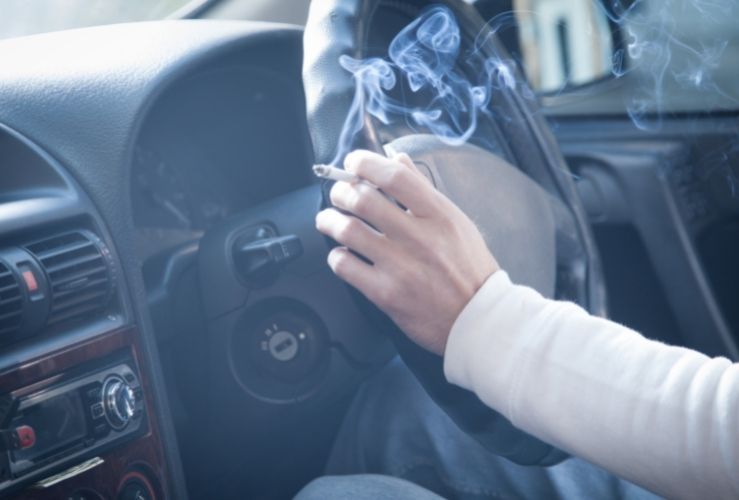 Woman smoking whilst driving car