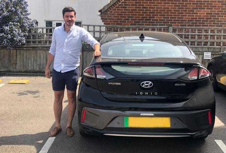 Shaun Hazlewood pictured next to his electric company car