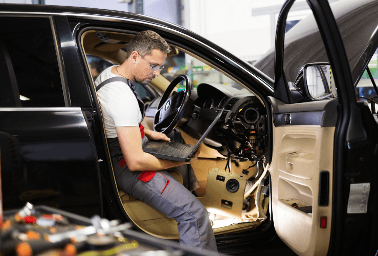 Mechanic using diagnostics to find out problem with car