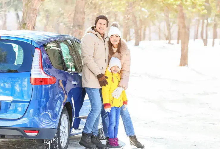 Family about to go on Christmas car trip