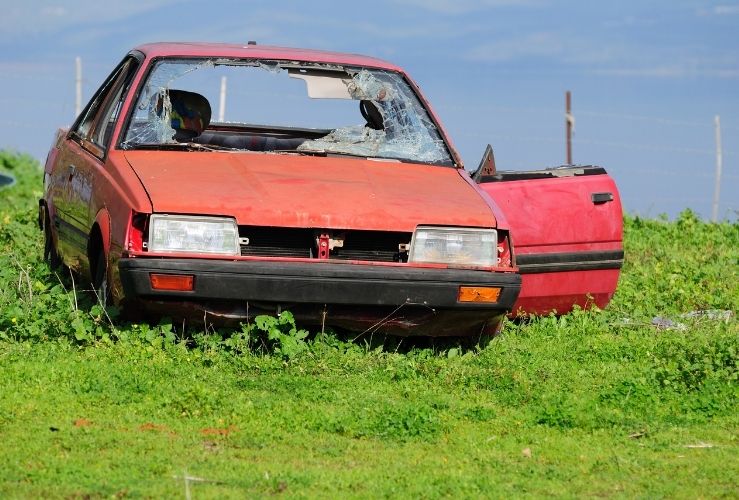 Abandoned car in field