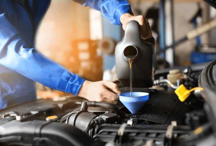 Mechanic refilling car oil