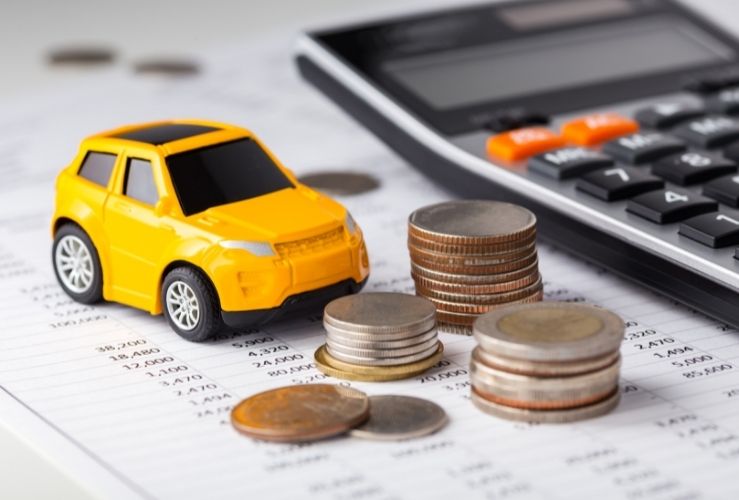 Image of toy car, money and calculator