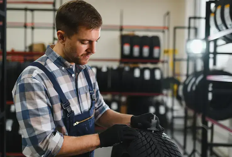 A mechanic looking at tyres