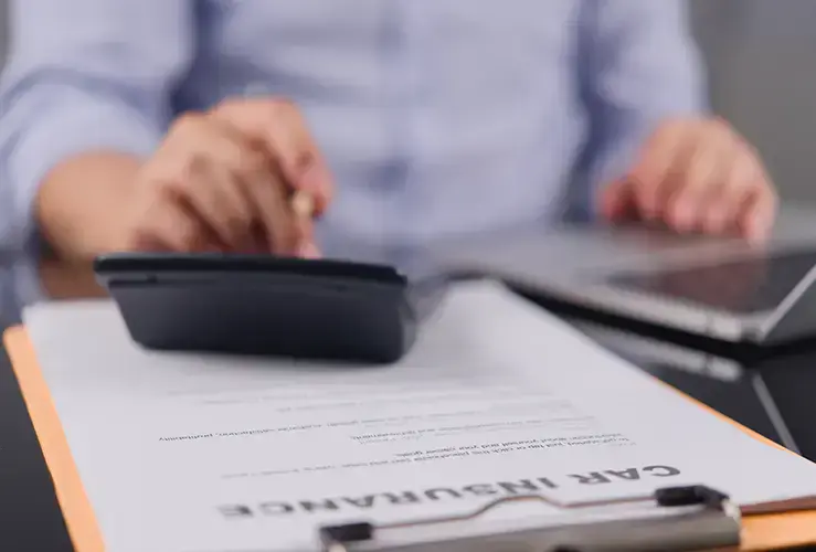 A person filling out a car insurance form