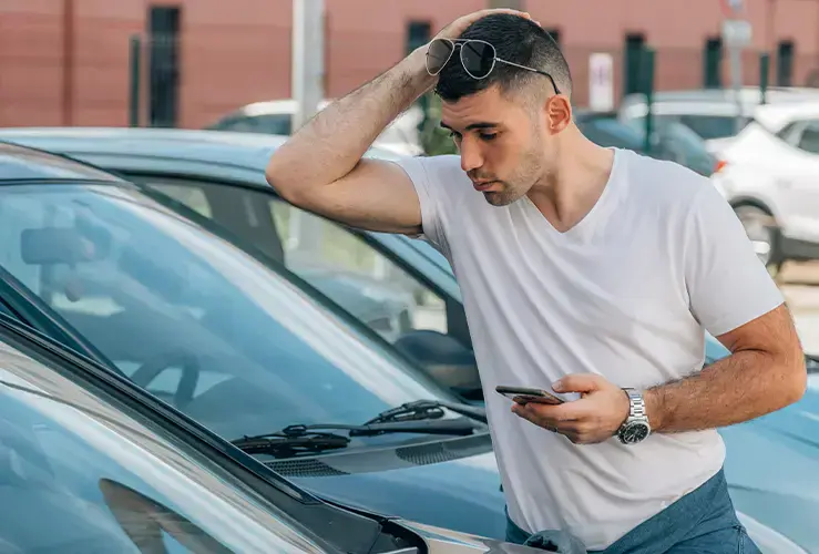 A man inspecting a car