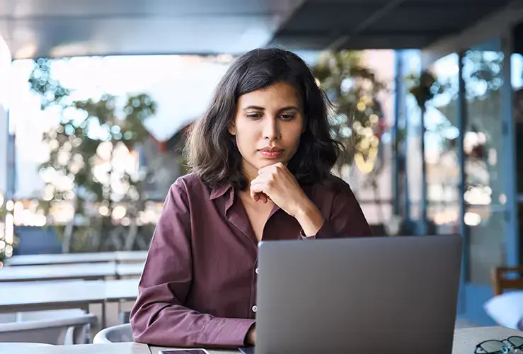 A woman looking at a laptop