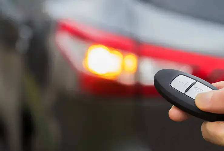 Person using key fob to unlock car
