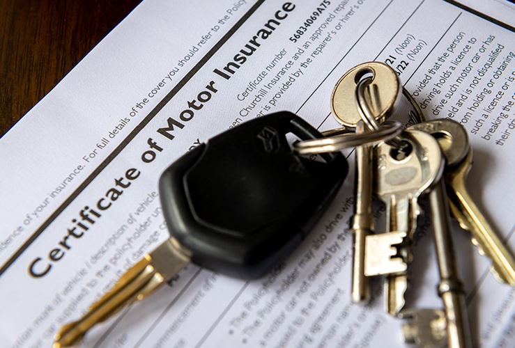 Keys on car insurance document 