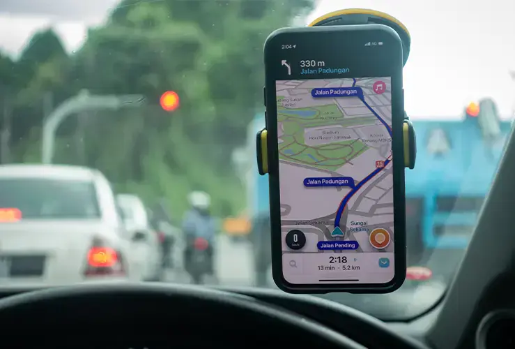 A driver using a sat nav app on their phone