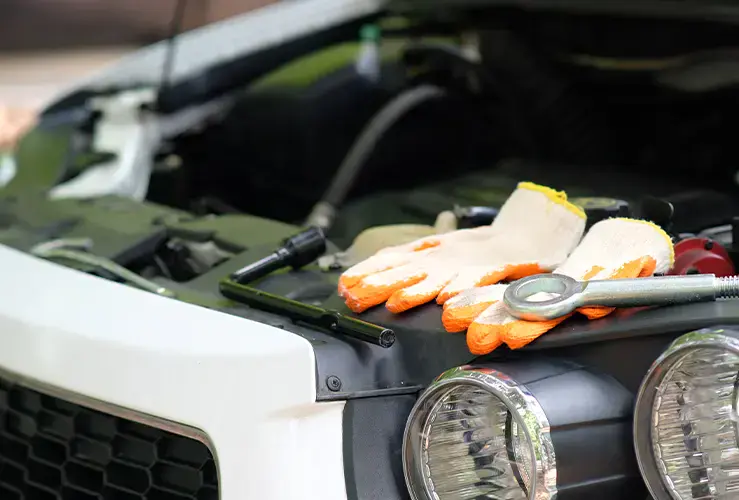 Gloves in the engine bay of a car