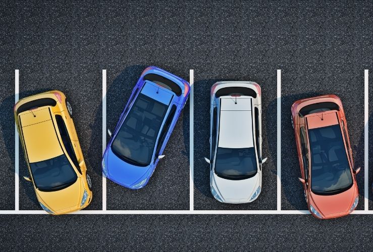 Image of cars parked outside of parking lines in car park