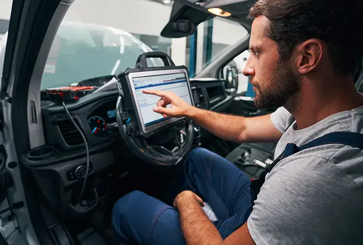 A mechanic using a car diagnostic software