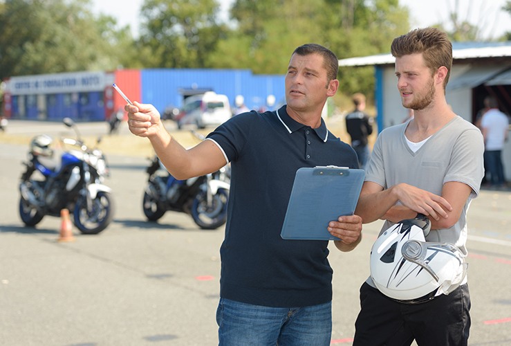 man receiving instructions at a motorcycle training course