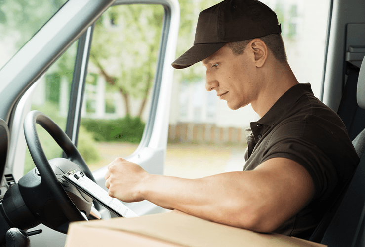 A delivery man looking at a checklist