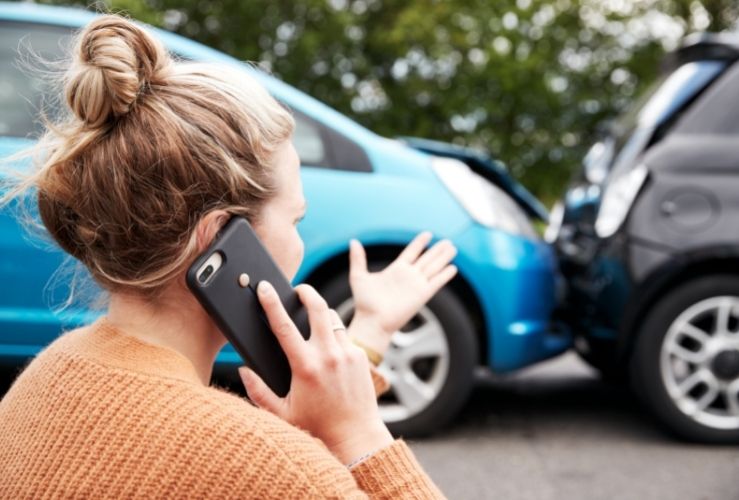 Woman on phone reporting car accident