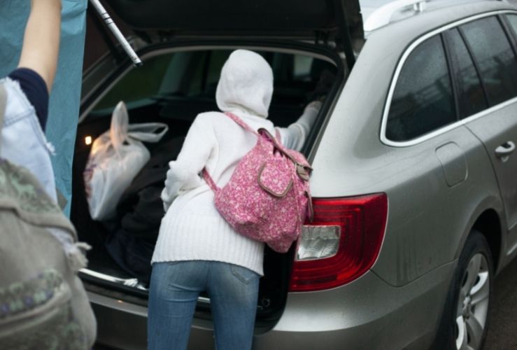 Woman getting stuff out of car boot