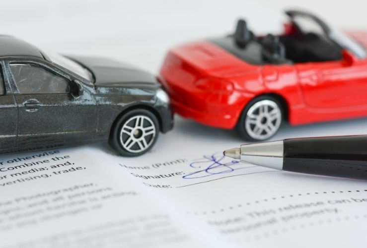 Toy cars portraying car insurance contract policy concept